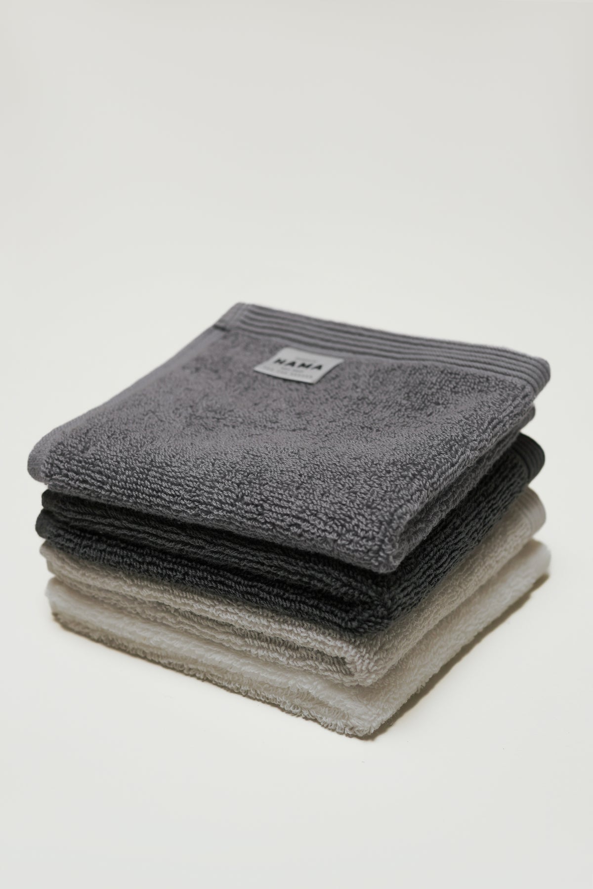 Seine, Bordered Cotton Face Cloth in Charcoal